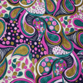 A close-up of a colorful abstract paisley pattern with swirling teal, pink, olive green, black, and white motifs on a light cream background.