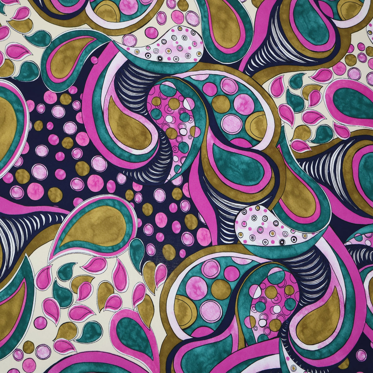 A close-up of a colorful abstract paisley pattern with swirling teal, pink, olive green, black, and white motifs on a light cream background.