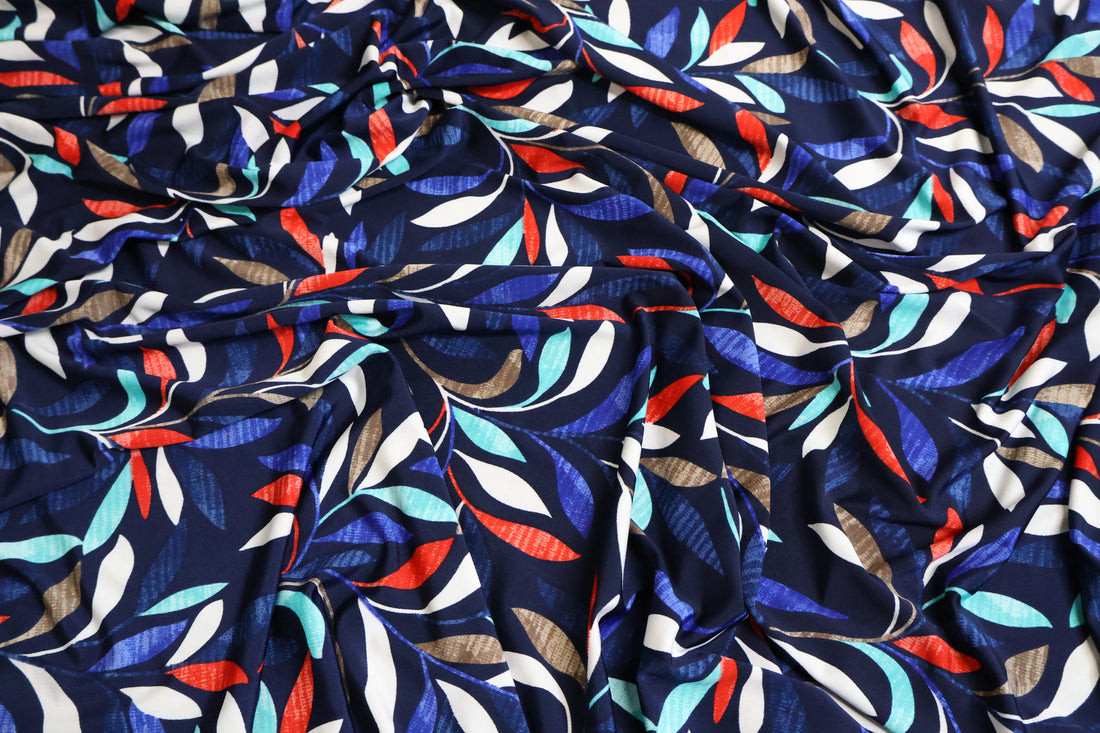 Mannequin wearing a colorful patterned dress against a plain background
